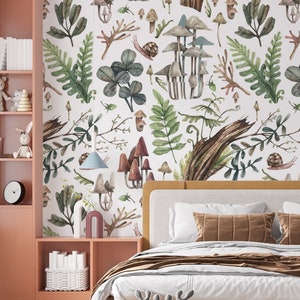 May include: A bedroom with a whimsical mushroom and foliage wallpaper. The room features a bed with a mustard-coloured frame, a pink bookshelf, and decorative items like a bear and reindeer plush toys.