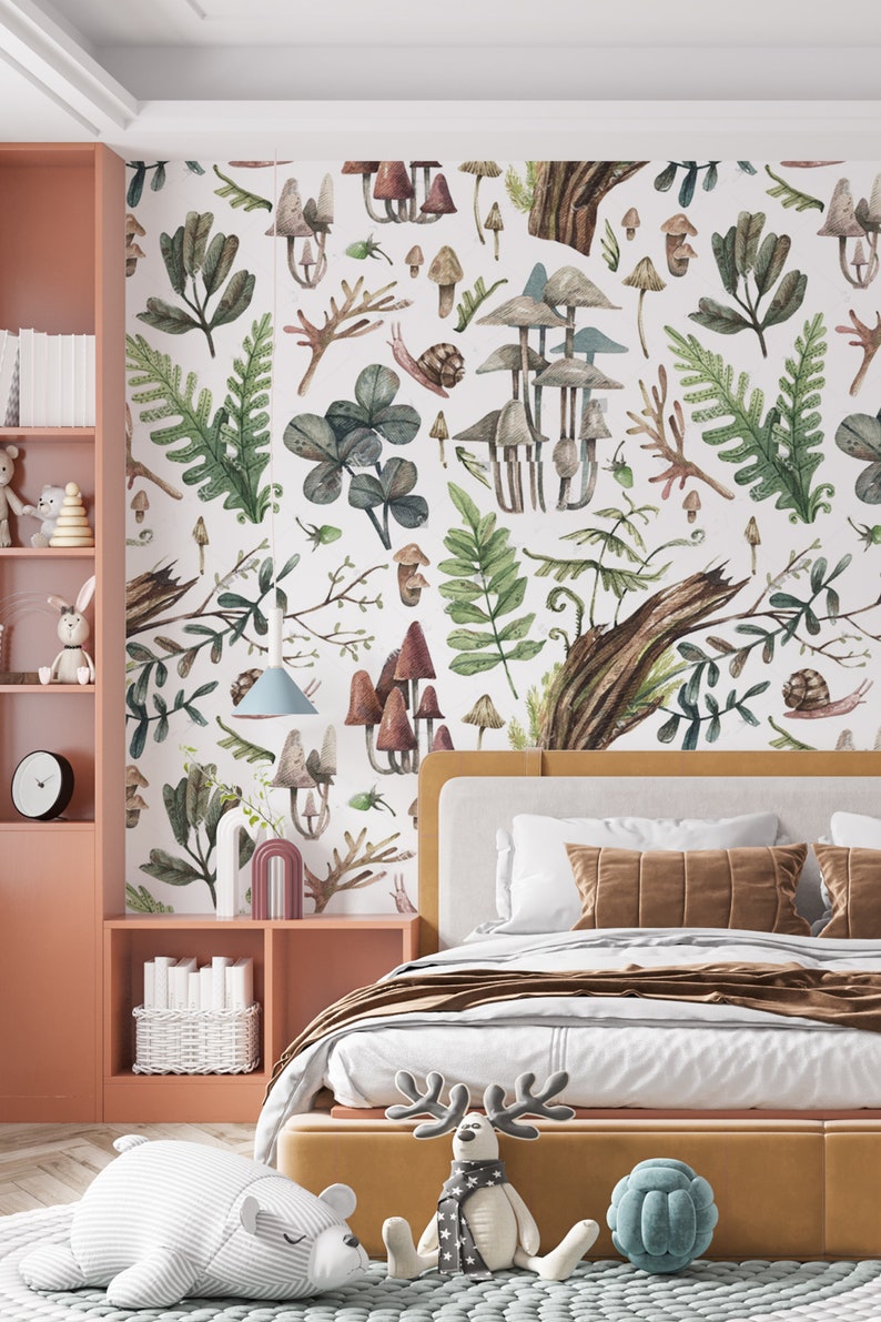 May include: A bedroom with a whimsical mushroom and foliage wallpaper. The room features a bed with a mustard-coloured frame, a pink bookshelf, and decorative items like a bear and reindeer plush toys.