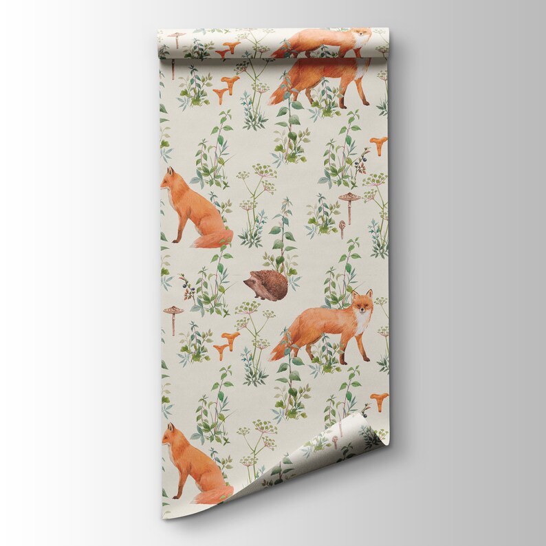 May include: A roll of wallpaper featuring a repeating pattern of foxes, mushrooms, and greenery. The foxes are a vibrant orange, and the mushrooms are tan. The background is a light beige color, creating a natural, woodland theme.