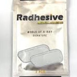 May include: Two white adhesive pads in a silver foil pouch. The pouch has the text "Radhesive" and "World Et X-Ray Signature" printed on it.