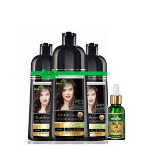 Könnte beinhalten: Produktfoto von drei schwarzen Flaschen 'Dark Brown Color Shampoo' und einer kleinen grünen Flasche Arganöl. Die Shampooflaschen haben ein grünes Band und zeigen das Gesicht einer Frau. Die Arganölflasche hat einen goldenen Deckel.