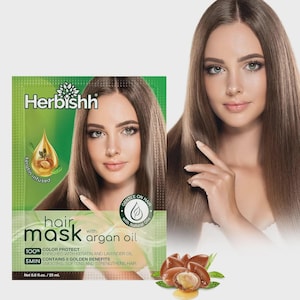 May include: A hair mask packet with the brand name "Herbishh" and the words "hair mask with argan oil." The packet features a woman with long, brown hair. The product promises color protection, enriched with keratin and lavender oil, and 8 golden benefits.