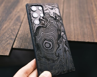 May include: A black phone case with a swirling, abstract pattern. The case has a raised camera bump with three lenses.