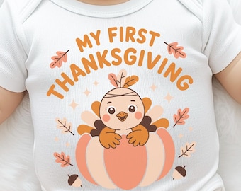 May include: White baby bodysuit with the text "MY FIRST THANKSGIVING" and a cartoon turkey in a pumpkin. The design includes fall leaves and acorns in shades of orange and brown. A festive outfit for a baby's first Thanksgiving.