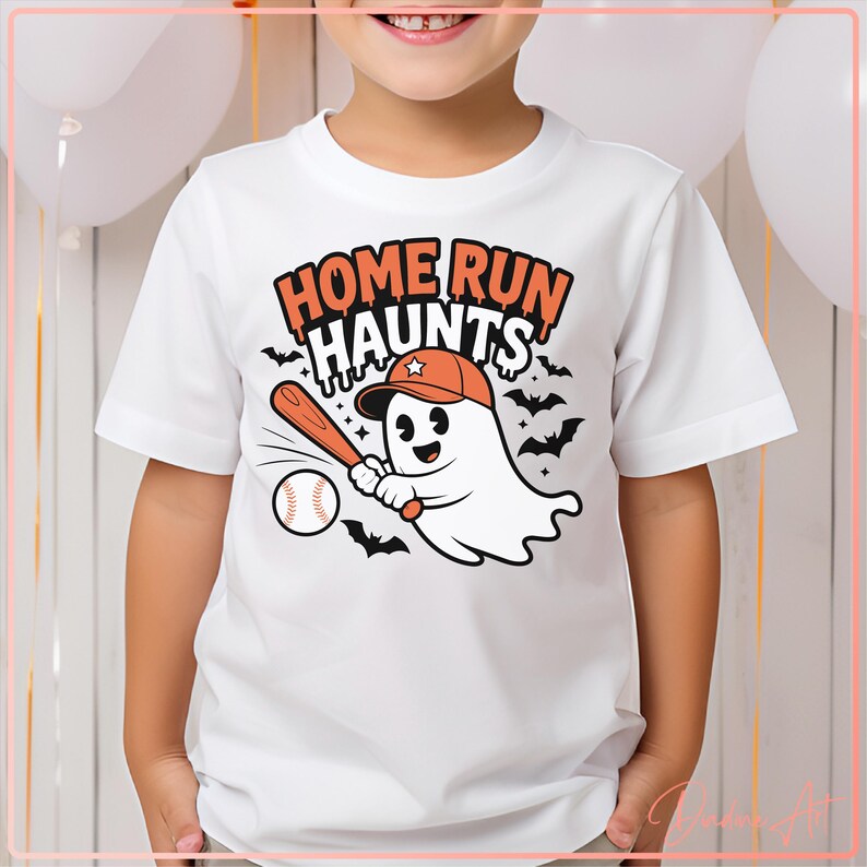May include: White t-shirt with a cartoon ghost wearing an orange baseball cap and holding a bat, ready to hit a baseball. The shirt has the text "HOME RUN HAUNTS" in orange and black, with bats in the background.