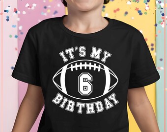 May include: Black t-shirt with white text that says "It's My 6th Birthday" with a white football graphic.