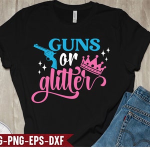 May include: Black t-shirt with the text "Guns or Glitter" in pink and blue. A blue gun and a pink crown are included in the design.