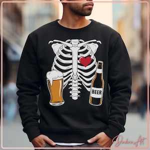 May include: Black sweatshirt with a white rib cage design, a red heart, a beer glass, and a beer bottle with the word "BEER". The sweatshirt is a casual style.