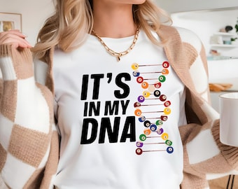 May include: White t-shirt with the text "It's in my DNA" and a graphic of a DNA strand made of billiard balls.