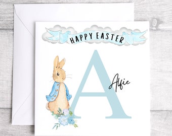 May include: A blue and white Easter card with a bunny rabbit and the letter A. The card says "Happy Easter" and the name "Alfie" is written on the card.