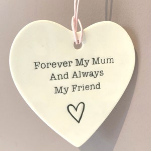 May include: White ceramic heart-shaped ornament with the text "Forever My Mum And Always My Friend" and a small heart design.