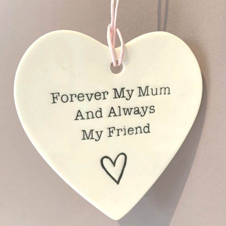 May include: White ceramic heart-shaped ornament with the text "Forever My Mum And Always My Friend" and a small heart design.
