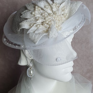 Handmade white fascinator made of sequin crinoline material with veil perfect for weddings and festive occasions