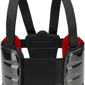 May include: A black rib protector vest featuring two rigid carbon-fibre-look side panels with three horizontal vents each. The vest includes adjustable black shoulder straps, a central back support pad, and a vibrant red interior lining.
