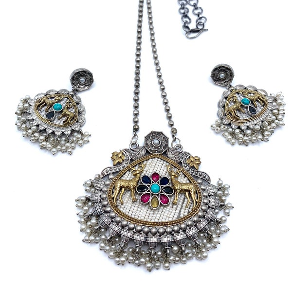 German silver pendant set in 2 tone gold silver plating with cute deer motifs, pearl piroyi & navratan stones. Classy navaratna pendant set.