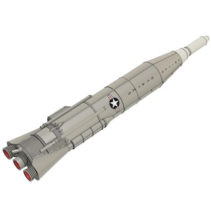 May include: A gray and white model rocket with the words "UNITED STATES" printed on the side. The rocket has a star and stripes emblem and three red exhaust nozzles. The rocket is a detailed illustration.