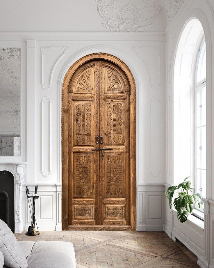 Elevate the aesthetic of your home with a hand-carved solid wood arched door from Etsy. These antique entrance front doors are available in custom sizes for double or single rustic exterior and interior sliding or hinged doors, adding a unique and timeless touch to any space. With intricate detailing and high-quality craftsmanship, these arched doorways will make a statement in your home.