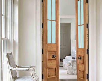 May include: A pair of wooden double doors with frosted glass panels and black hardware. The doors are open and reveal a carpeted room with a white couch.