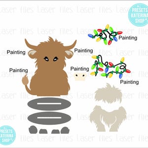 May include: A brown Highland cow with a white nose and black eyes, sitting on a gray platform with two gray lines. The cow is surrounded by four gray rocks. There are four strings of colorful Christmas lights in the background.