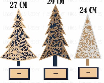 May include: Three wooden Christmas tree ornaments with snowflake designs. The trees are 27 cm, 29 cm, and 24 cm tall. The trees are painted in shades of brown, gold, and white.