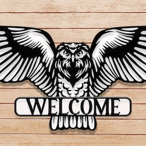 May include: Black metal owl with outstretched wings and the word "WELCOME" on a banner below. The owl is against a woodgrain background.