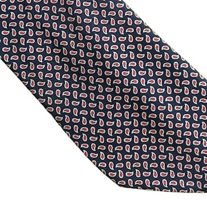 May include: A dark blue necktie with a paisley pattern in white and red.