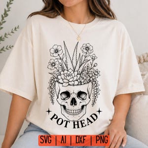 May include: Cream-colored t-shirt featuring a black and white skull design with a floral arrangement sprouting from the skull's head. The text "POT HEAD" is below the skull. The bottom of the shirt has the text "SVG | AI | DXF | PNG".