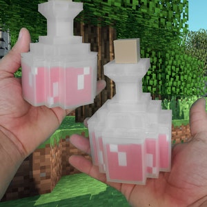 May include: Two clear, pixelated potion bottles with pink liquid and tan stoppers. The bottles are held in hands against a pixelated green and brown background, reminiscent of a video game setting.