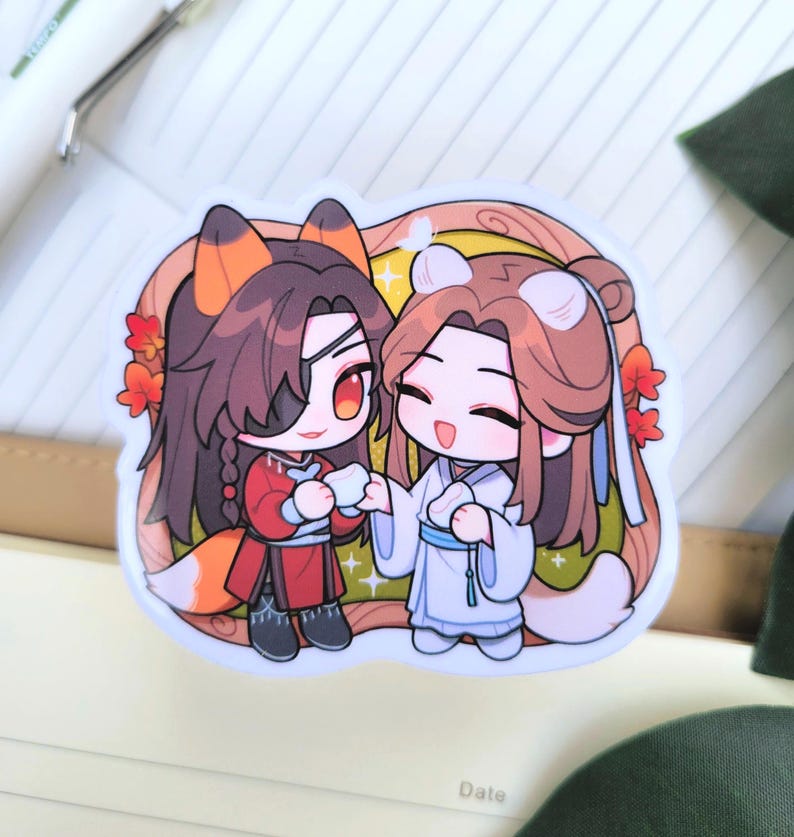 May include: A sticker depicting two anime-style characters. One is in red with fox features, the other in white with bear features. They are holding hands. The background is light brown with red flowers.