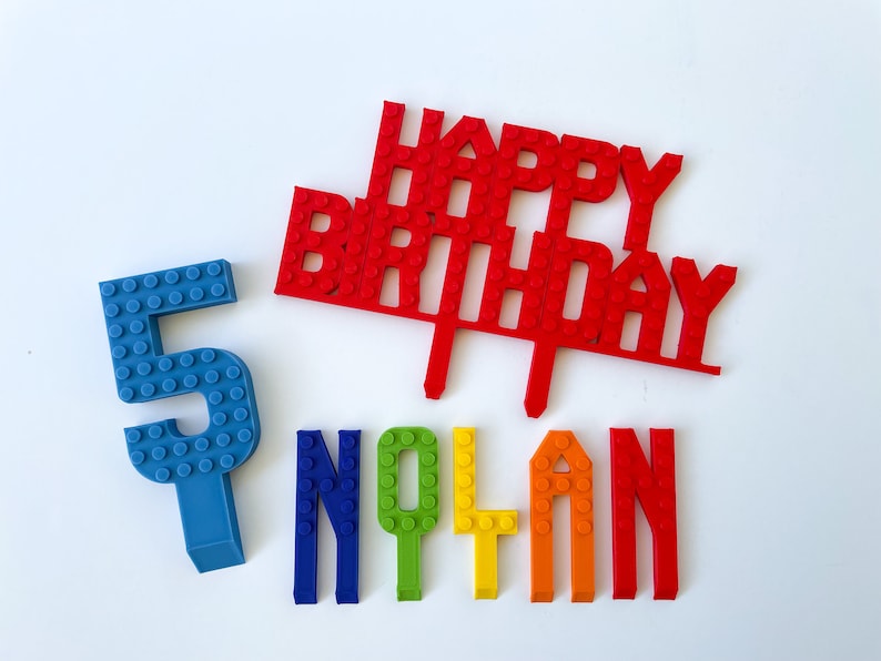 Happy Birthday cake sign, number and name set that are made as LEGO bricks.