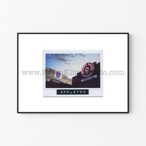 May include: A vintage Polaroid photo of a building with a sign that says "Golden Nickel" and a Pabst Blue Ribbon sign. The photo is labeled "Appleton" at the bottom.