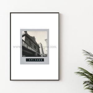 May include: Black and white photograph of a building in Chicago. The photo is framed in a black frame and has a gray mat.