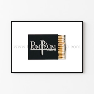May include: A black matchbox with the text "Pump Room" and "October 17, 1998" printed in white. The matchbox is open and contains a stack of matches with white tips.