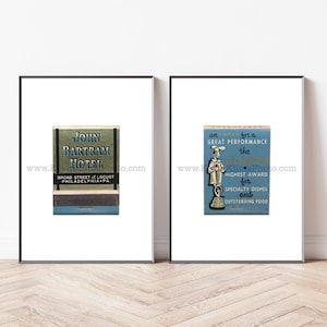 May include: Two framed vintage matchbook covers. The left cover is blue and gold with the text "JOHN BARTRAM HOTEL" and "BROAD STREET & LOCUST PHILADELPHIA PA". The right cover is blue and white with the text "an for a GREAT PERFORMANCE the HIGHEST AWARD for SPECIALTY DISHES and OUTSTANDING FOOD".
