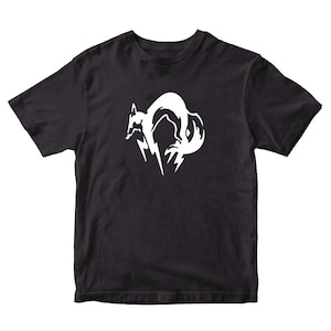 May include: Black t-shirt with a white graphic of a stylized fox head.