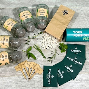 May include: A home-grow herb kit featuring four clear glass jars with labels for thyme, sweet basil, rosemary, and parsley. Includes a brown paper bag of white drainage stones, five wooden plant markers, and five green seed packets for herbs.