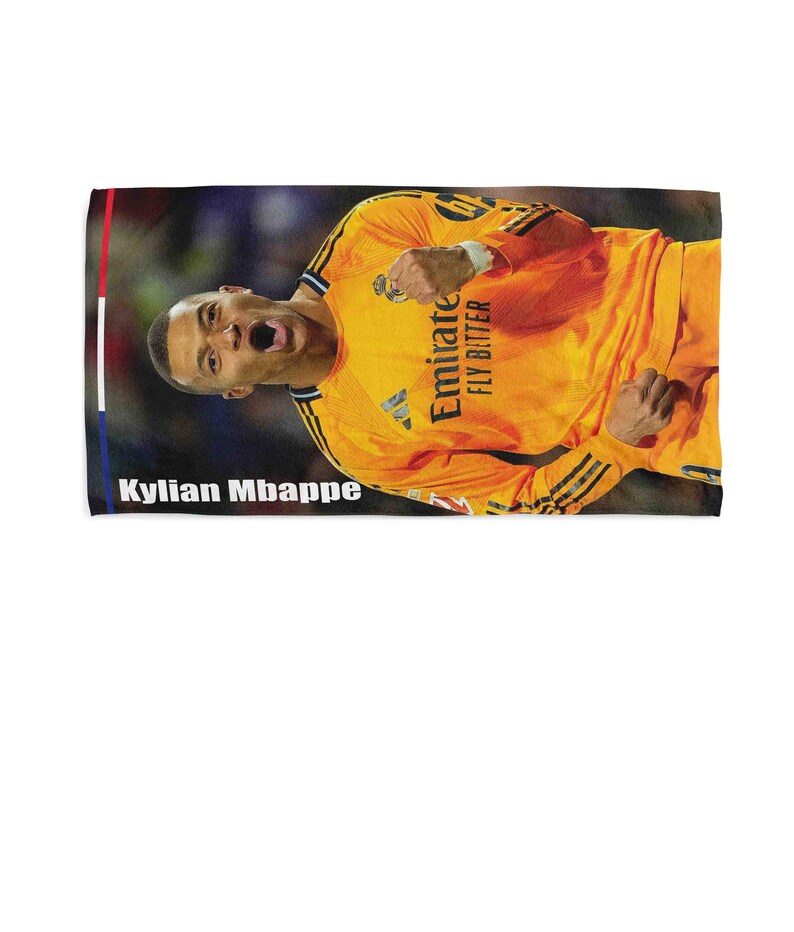 May include: A rectangular towel featuring a vibrant image of Kylian Mbapp&eacute; in an orange jersey. The towel has a colorful border with the text "Kylian Mbappe" at the bottom. The jersey has the text "Emirate FLY BETTER".
