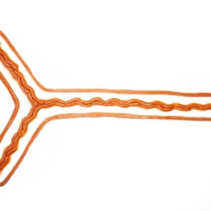 May include: A close-up of a Y-shaped model of a human fallopian tube. The tube is made of a flexible, translucent material with a brown inner lining.