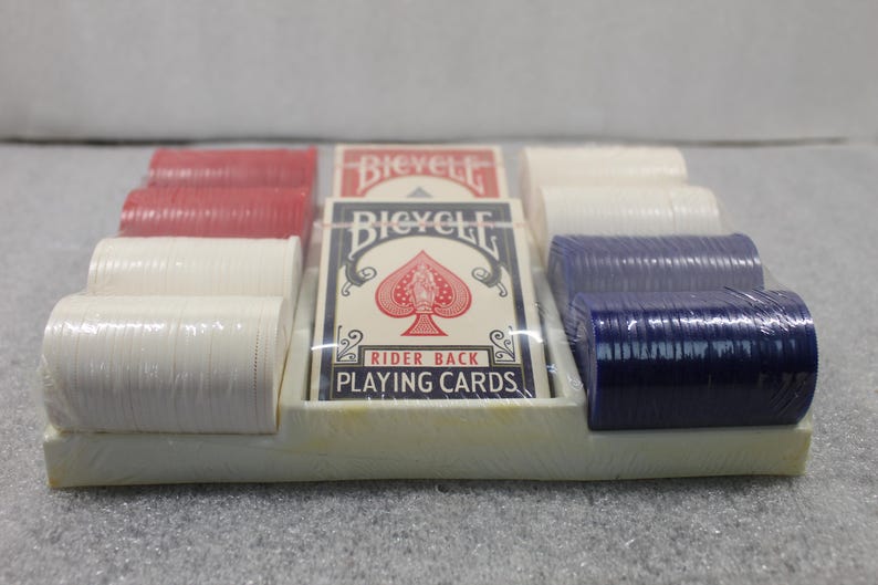 Pu&ograve; includere: Un set di poker confezionato con carte da gioco e pile di fiches da poker rosse, bianche e blu. Le carte da gioco sono del marchio "Bicycle Rider Back Playing Cards". Il set &egrave; in un vassoio di plastica bianco.