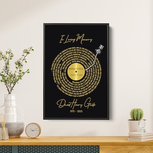 May include: A black and gold vinyl record memorial print with the text "In Loving Memory" and a song title and artist name placeholder. The print features a gold record with lyrics in a circular pattern and a silver record player arm. The bottom of the print includes the name "David Henry Galle" and the dates "1973 - 2023".
