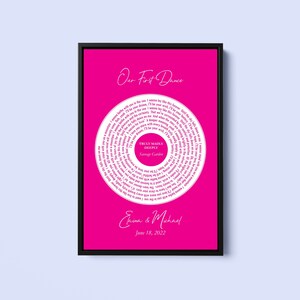 May include: A pink printable wedding sign with a white circle in the center. The circle contains a spiral of white text that reads "Our First Dance" and the lyrics to the song "Truly Madly Deeply" by Savage Garden. The text at the bottom of the sign reads "Erina & Michael" and "June 18, 2022".