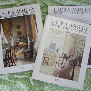 May include: Two Laura Ashley home decoration magazines from 1983 and 1984. The covers feature interior design photos with a vintage aesthetic. The 1983 magazine costs £1.00 and the 1984 magazine costs £1.25.