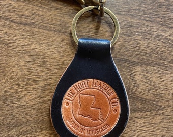 Horween Shell Cordovan keychain. Two tone black with tan inlaid logo. Fish hook ring.
