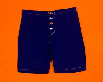 May include: Navy blue sleep shorts with white stitching and orange buttons.