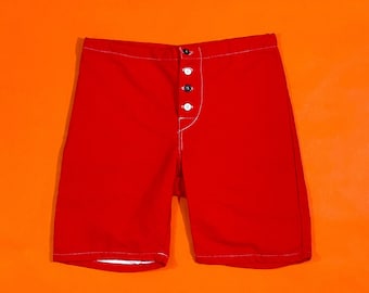 May include: Red boxer shorts with a white button fly.