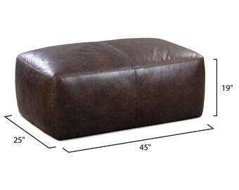 May include: A rectangular brown leather ottoman, 114 cm long, 64 cm wide, and 48 cm high. The ottoman has a soft, rounded shape and is made of a dark brown leather material. It is a piece of furniture.