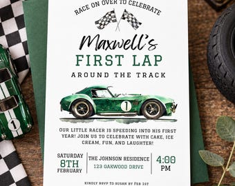 May include: A white rectangular invitation card with black and green text reading Race on over to celebrate Maxwell's first lap around the track. It features a green race car illustration with the number one and two checkered flags.