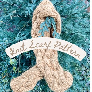 May include: A brown knit scarf with a cable knit pattern. The scarf is draped over a green bush and the text "Knit Scarf Pattern" is written in a white banner.