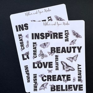 May include: Two sheets of white sticker paper with black and white butterfly illustrations and motivational words like "inspire", "love", "create", and "believe".
