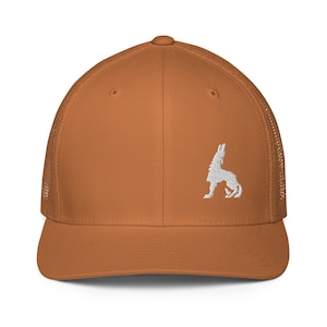May include: A brown and white trucker hat with a white embroidered silhouette of a wolf howling at the moon. The hat has a mesh back.